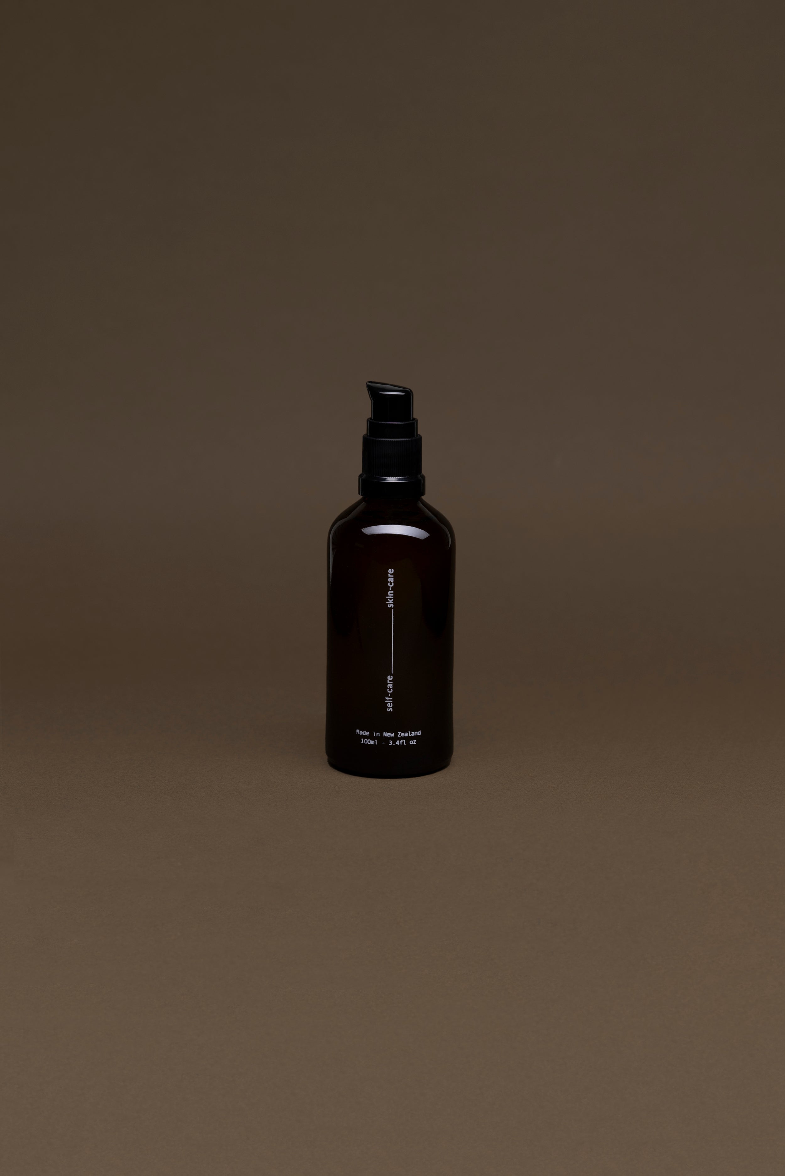 Back view of Tahi Skincare Facial Cleansing Oil with Manuka and Propolis, showing ingredients and product details on a minimal amber bottle.