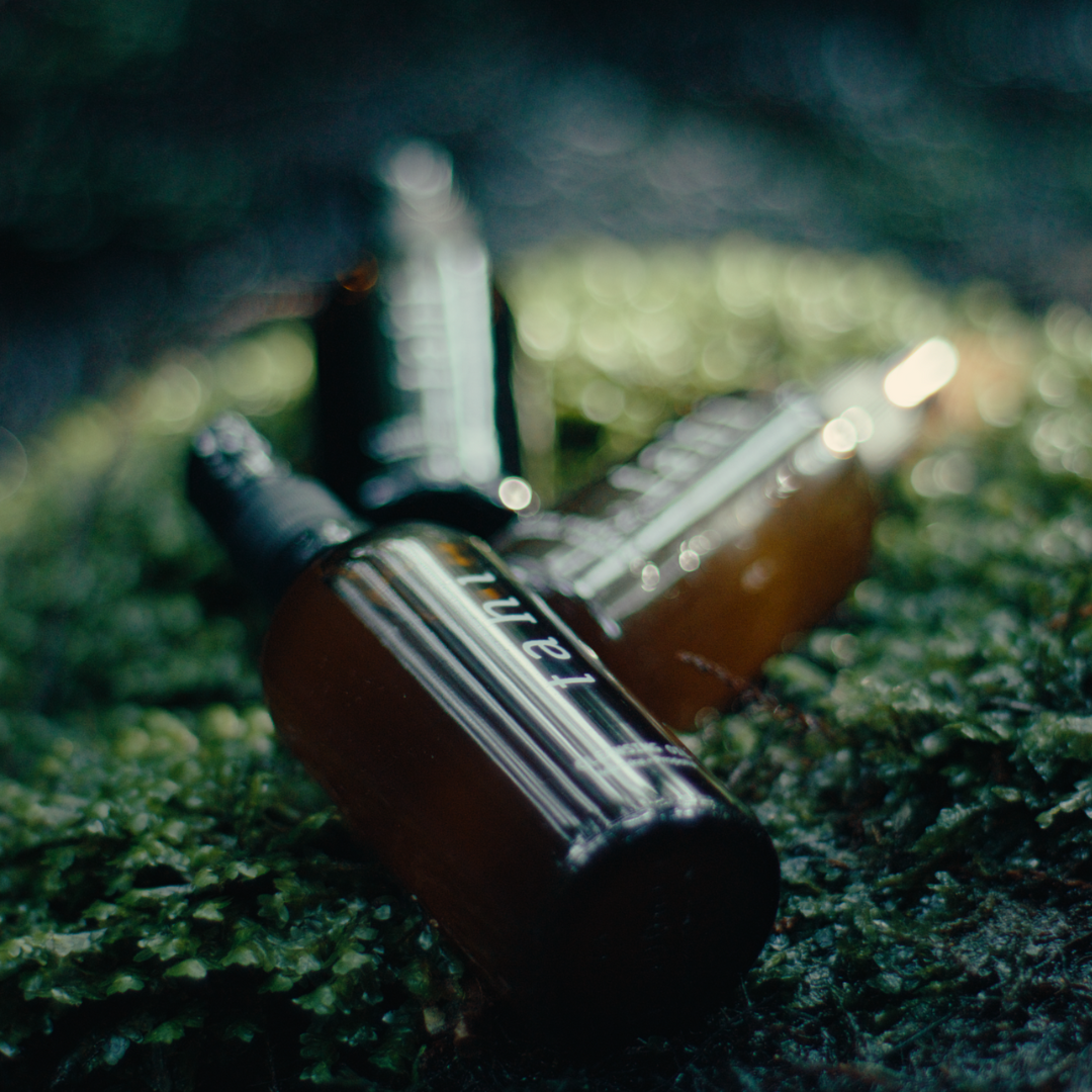 Tahi brand cleansing oil bottle placed among mossy ground
