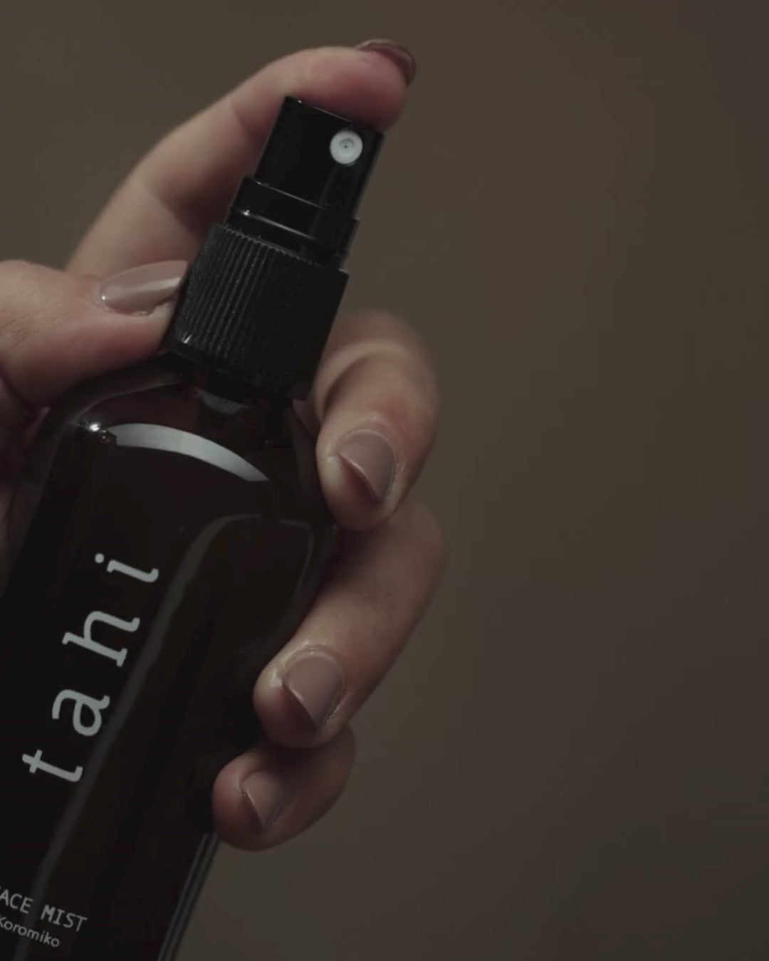 Tahi brand facial mist being slowly spritzed.