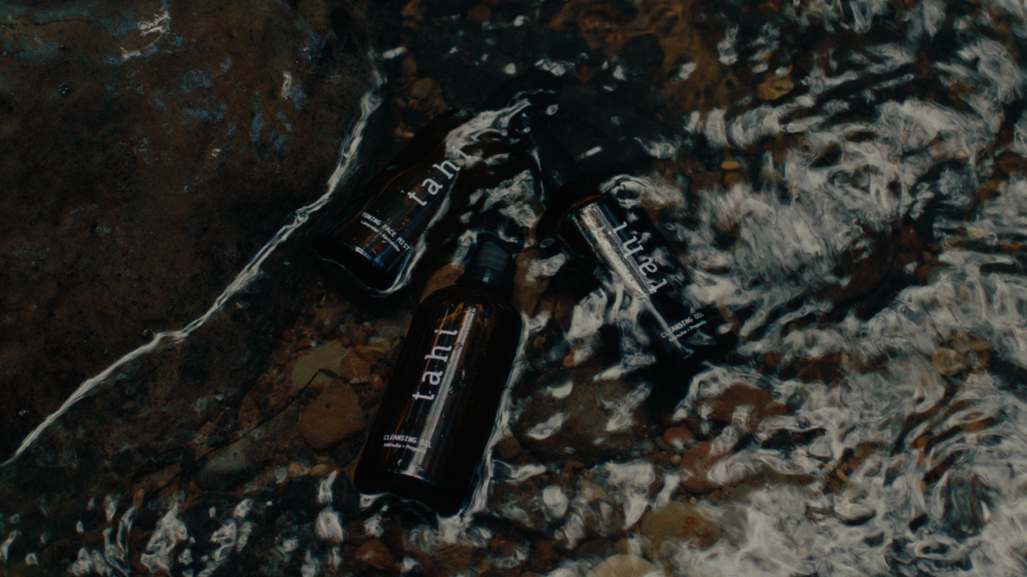 tahi three bottles in river water
